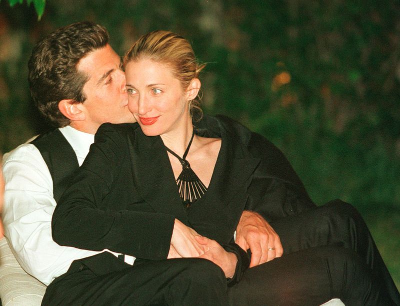 WASHINGTON - MAY 1:  (FILE PHOTO) (ITALY OUT) John F. Kennedy, Jr. editor of George magazine, gives his wife Carolyn Bessette Kennedy a kiss on the cheek during the annual White House Correspondents dinner May 1, 1999 in Washington, D.C. July 16, 2003 marks the four year anniversary of the plane crash which killed Kennedy, his wife and sister-in-law. (Photo by Tyler Mallory/Getty Images)