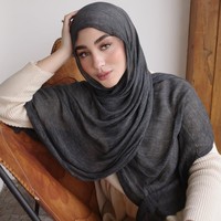Margin Wieheerm tampil memukau dengan perpaduan pashmina crinkle viscose polos hitam yang disampirkan ke depan, menciptakan siluet wajah yang tegas namun tetap terlihat lembut. Foto: Dok. Instagram @marginw.