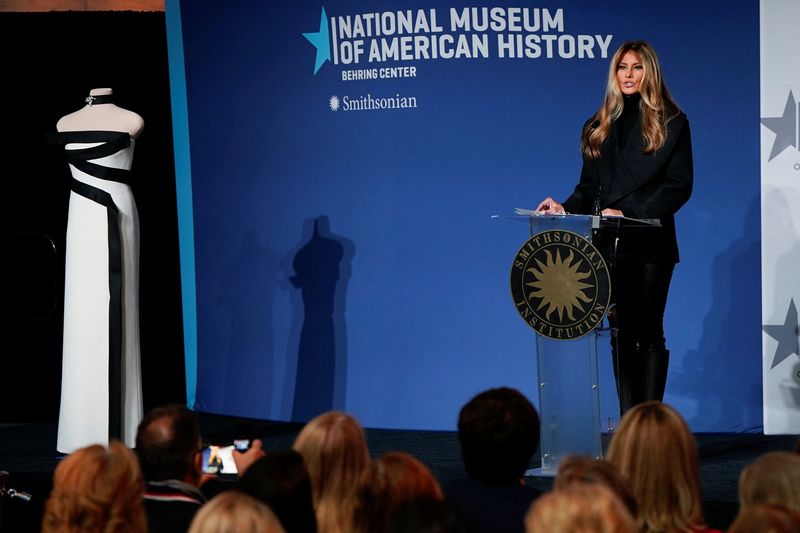 U.S. first lady Melania Trump stands next to her 2025 inaugural gown as it is displayed in the First Ladies Gallery at the Smithsonian's National Museum of American History in Washington, D.C., U.S., February 20, 2026. REUTERS/Elizabeth Frantz