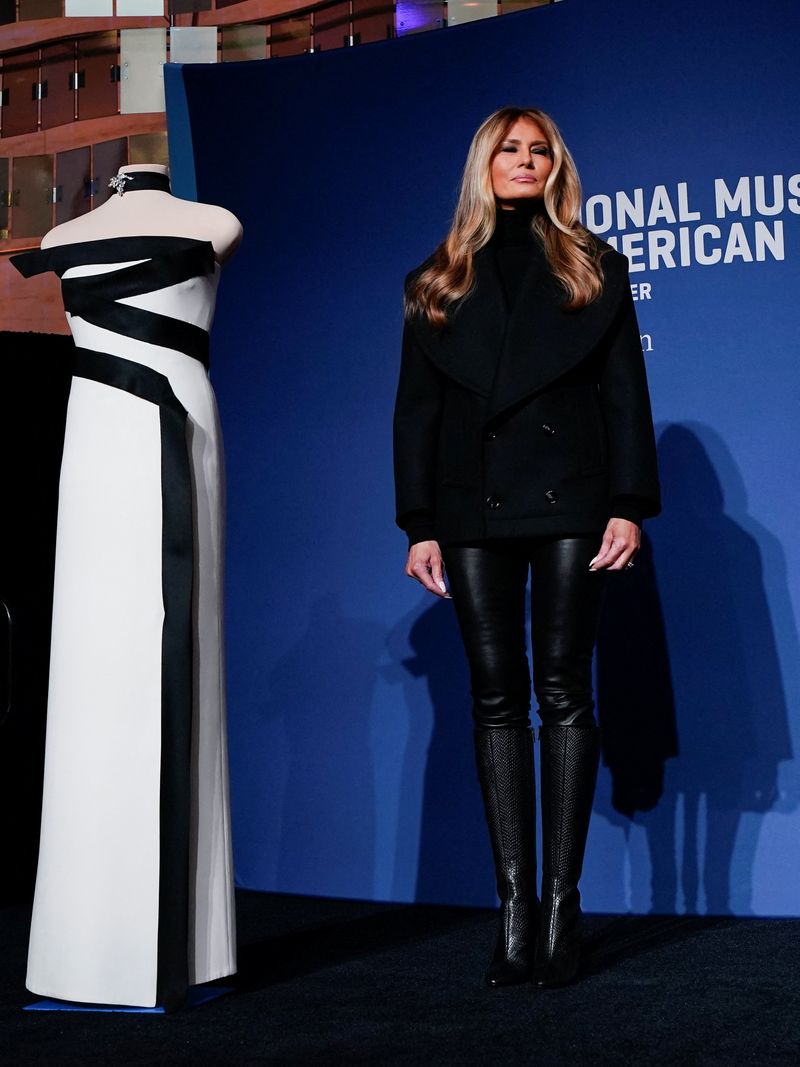 U.S. first lady Melania Trump stands next to her 2025 inaugural gown as it is displayed in the First Ladies Gallery at the Smithsonian's National Museum of American History in Washington, D.C., U.S., February 20, 2026. REUTERS/Elizabeth Frantz