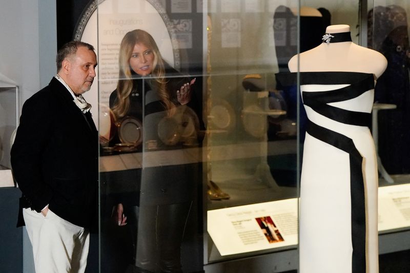 U.S. first lady Melania Trump stands next to her 2025 inaugural gown as it is displayed in the First Ladies Gallery at the Smithsonian's National Museum of American History in Washington, D.C., U.S., February 20, 2026. REUTERS/Elizabeth Frantz