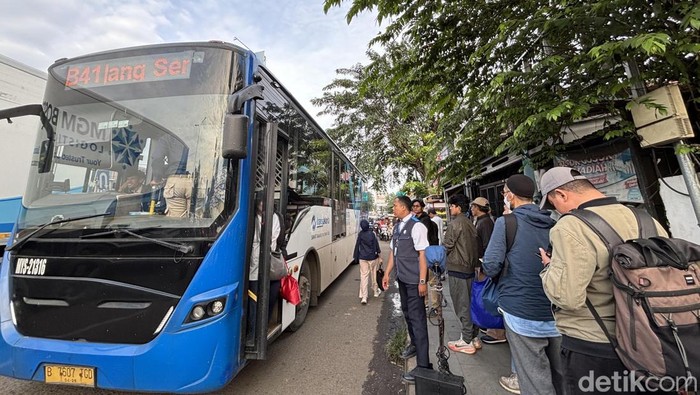 Penumpang TransJakarta di Jatiasih, Bekasi, mengantre di pinggir jalan karena tidak ada halte.