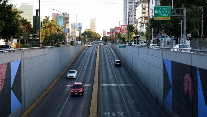 Police officers patrol at a main square of the city, which is almost empty after a series of blockades and attacks by organized crime following a military operation in which Mexican officials said cartel boss Nemesio Oseguera, 