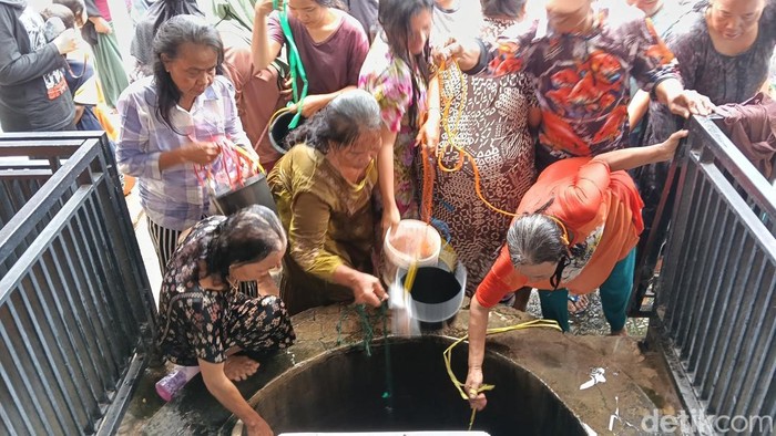 Puluhan warga bergantian menimba air di Sumur Pengantin yang ada di Masjid Pusaka Baiturrahman, Desa Dermayu, Jumat (27/2/2026).