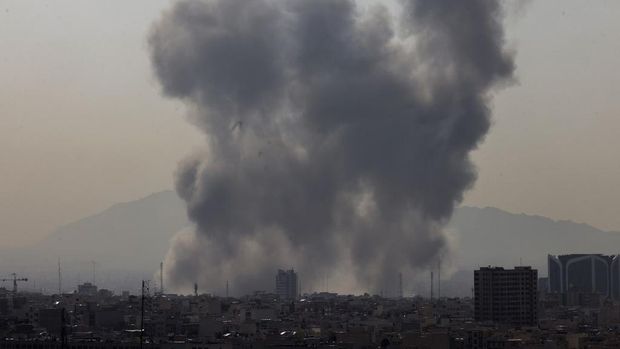 A plume of smoke rises following a reported explosion in Tehran on February 28, 2026. Two loud blasts were heard in Tehran on February 28 morning by AFP journalists, and two plumes of thick smoke were seen over the centre and east of the Iranian capital. Israel's defence ministry announced it had launched a 