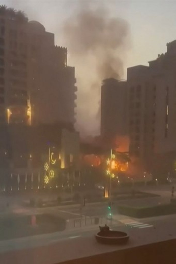This video grab taken from UGC images posted on social media on February 28, 2026, shows smoke and flames rising from Dubais landmark The Palm archipelago, as Iran carried out retaliatory strikes in the Gulf following US and Israeli attacks. The Uni