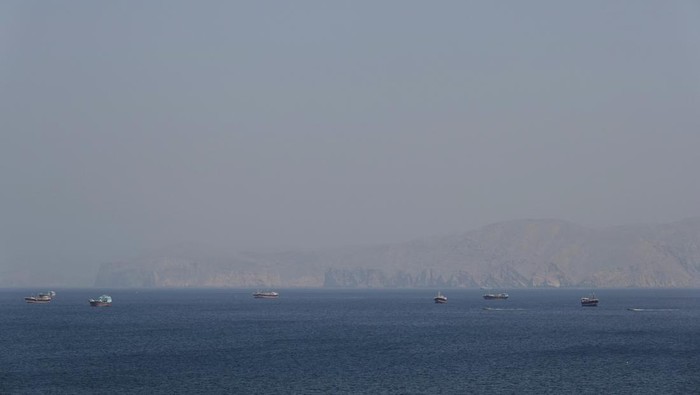 Birds fly near a boat in the Strait of Hormuz amid the U.S.-Israeli conflict with Iran, as seen from Musandam, Oman, March 2, 2026.REUTERS/Amr Alfiky
