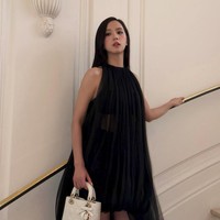 Gaun tersebut memiliki detail ekor panjang pada salah satu sisinya, menyempurnakan keanggunan visual grup BLACKPINK itu. Ia pun tampak menjinjing koleksi Lady Dior berwarna putih. Foto: dok. X