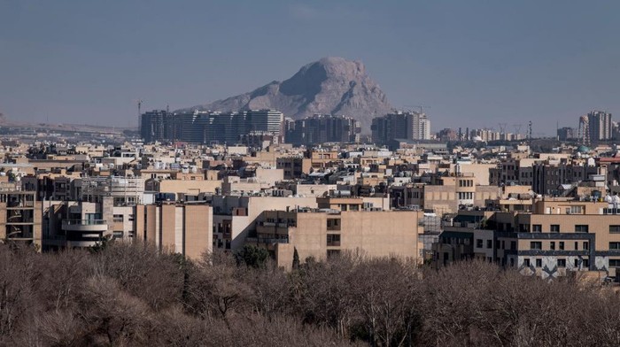An illustrated photograph shows a reflection of Iran's Supreme Leader, Ayatollah Ali Khamenei, captured in a hotel window with a view of a street in the historic city of Isfahan, Iran, on February 22, 2025. (Photo by Morteza Nikoubazl/NurPhoto via Getty Images)
