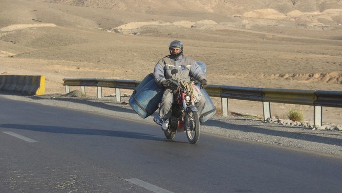 A man on a motorcycle gets his bike refuelled with petrol, brought from Iran, amid the U.S.-Israel conflict with Iran, at a shop in Quetta, Pakistan, March 4, 2026. REUTERS/Naseer Ahmed