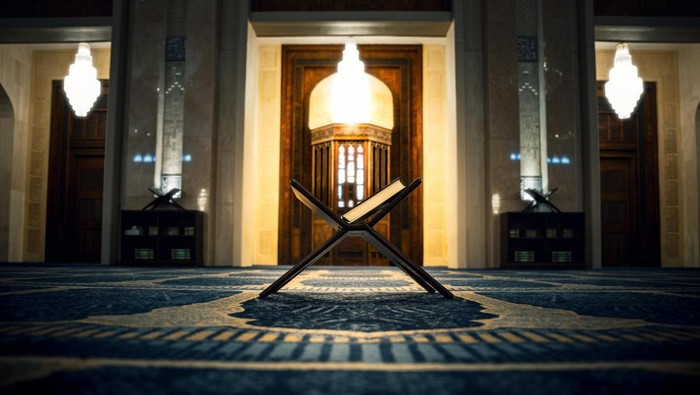 Ilustrasi Al-Quran di tengah masjid. Latar belakang gelap. Malam Nuzulul Quran