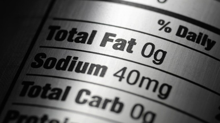 Macro of a nutrition ingredients label on a silver aluminum diet pop can.