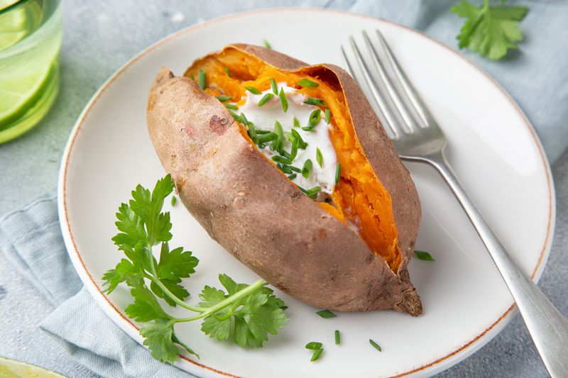 baked sweet potato with yogurt sause. Top view. Copy space.
