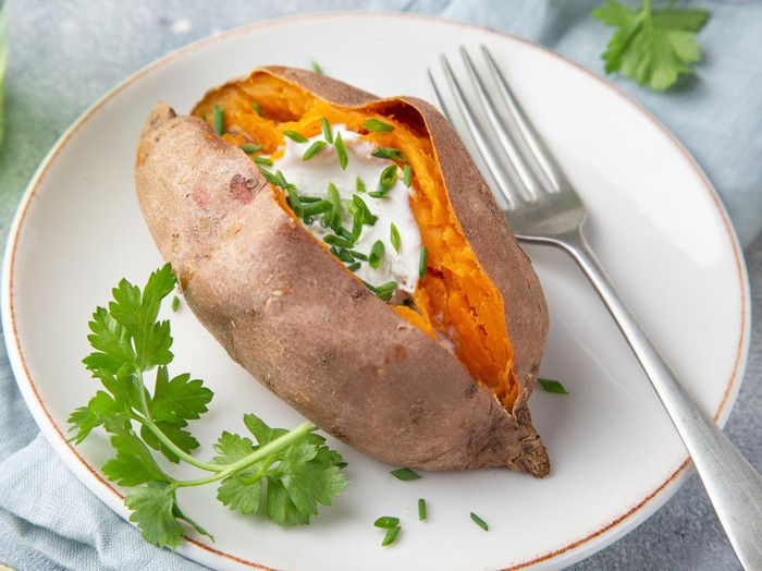 baked sweet potato with yogurt sause. Top view. Copy space.