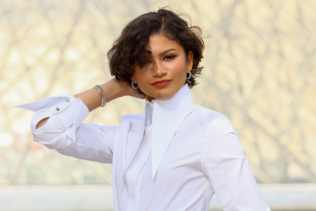 Zendaya mengandalkan tampilan klasik dengan gaya rambut curly French bob yang chic. Namun, fashion statement yang lebih nyata hadir lewat pilihan busananya yang menunjukkan status baru Zendaya sebagai pengantin baru. (Foto: Marc Piasecki/WireImage)