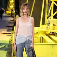 Atasan oversized itu dipadukan dengan celana denim longgar. Ia melengkapi tampilannya dengan sepatu high helles. perpaduan tan dan hitam. Aksesori yang dikenakan Robbie juga minimal. Ia membawa tas abu-abu Chanel rantai silver dan menggenggam scarf di tangannya.  Foto: WWD via Getty Images/WWD