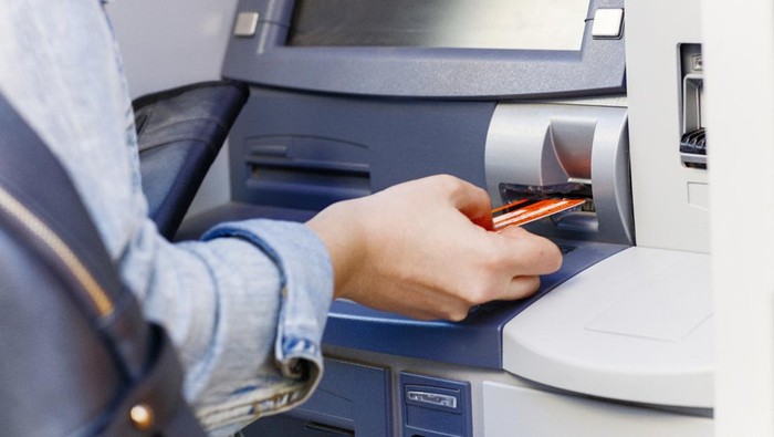 Hand inserting ATM credit card