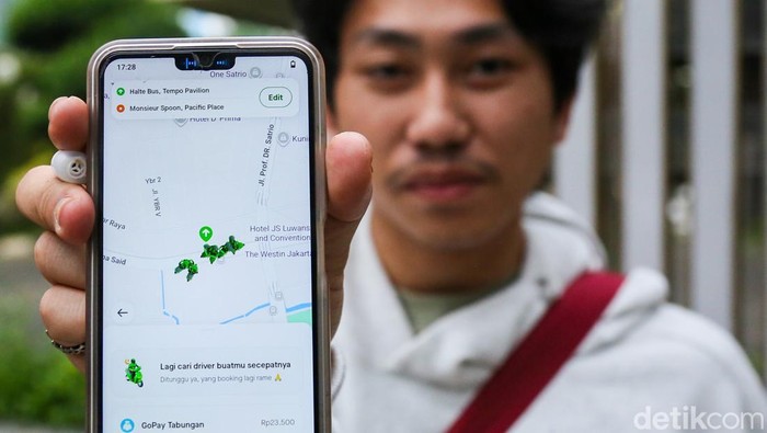 Sejumlah warga menunggu pengemudi ojek online di kawasan Jalan Rasuna Said, Kamis (12/3/2026), di tengah keluhan lamanya waktu tunggu layanan transportasi daring.