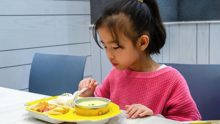 The little girl is eating