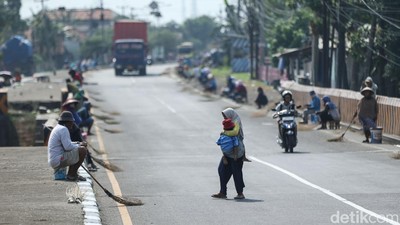 Bahaya Mengancam, Penyapu Koin Bawa Anak di Jembatan Kali Sewo