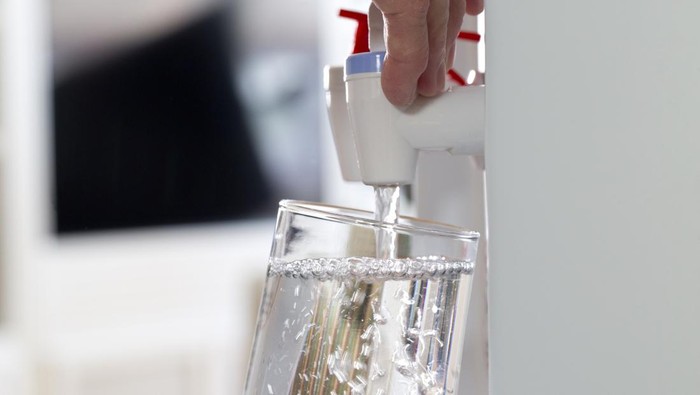 Glass being filled at a water cooler
