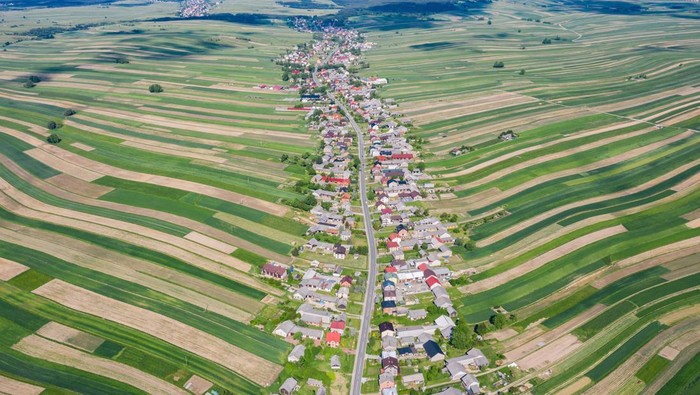Village from drone aerial view. Suloszowa village in Krakow County, Lesser Poland Voivodeship, in southern Poland. Beautiful village with houses and fields in Poland. Village in the middle of the fields