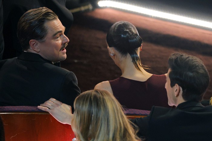 Leonardo DiCaprio speaks with Adrien Brody during the Oscars show at the 98th Academy Awards in Hollywood, Los Angeles, California, U.S., March 15, 2026. REUTERS/Mike Blake