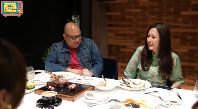 Maia memilih tampil simpel elegan dalam balutan kemeja hijau dengan motif floral. Wajahnya tampak natural lengkap dengan lipstik nude di bibirnya. Foto: YouTube/MAIA ALELDUL TV