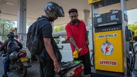Seorang petugas sedang mengisi BBM ke motor pembeli di SPBU. Pemerintah memberlakukan pembatasan distribusi, termasuk kuota pengisian per kendaraan serta pengawasan untuk mencegah penimbunan. REUTERS/Thilina Kaluthotage