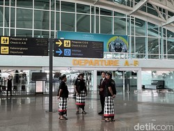 Pecalang berkoordinasi dengan petugas Bandara I Gusti Ngurah Rai, memastikan tidak ada wisatawan yang tercecer.