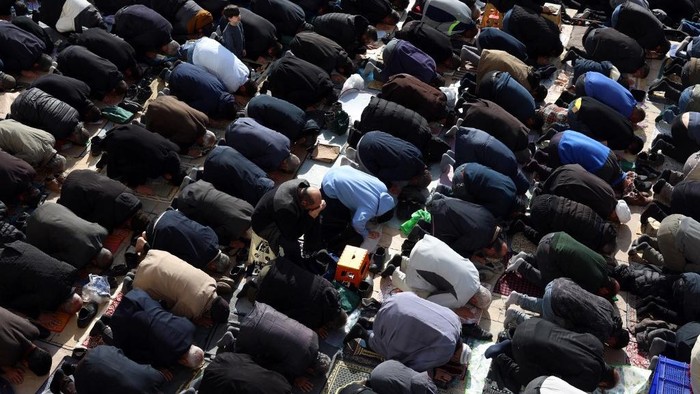Warga Iran mengikuti salat Idulfitri, menandai berakhirnya bulan suci Ramadan, di Masjid Agung Mosalla di Teheran pada 21 Maret 2026. Ibu kota Iran telah dibombardir hampir setiap hari sejak serangan gabungan AS-Israel memulai perang pada 28 Februari