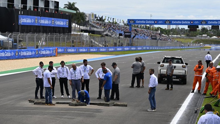 GOIANIA, BRAZIL - MARCH 21: 0fficials repair a sinkhole on the start finish straight during qualifying ahead of the MotoGP of  Brazil at Autodromo Internacional de Goiania - Ayrton Senna on March 21, 2026 in Goiania, Brazil. (Photo by Gold & Goose Ph