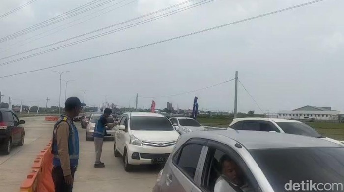 Petugas PJR Jatim menjemput kartu tol pengendara untuk mencegah kemacetan di GT Situbondo Barat.