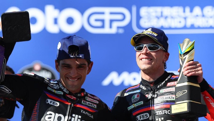 MotoGP - Brazil Grand Prix - Autodromo Internacional Ayrton Senna, Goiania, Brazil - March 22, 2026 Aprilia Racings Marco Bezzecchi celebrates on the podium after winning the Brazil Grand Prix alongside second place Aprilia Racings Jorge Martin REU