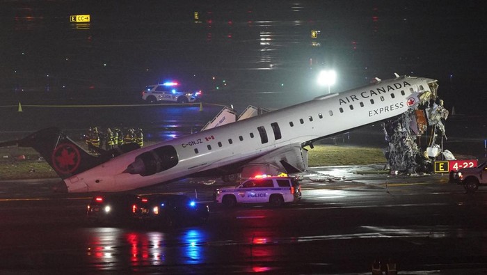Emergency crews work around an Air Canada Express jet that had collided with a ground vehicle at New York's LaGuardia Airport in Queens, New York, U.S. March 23, 2026.  REUTERS/Bing Guan     TPX IMAGES OF THE DAY