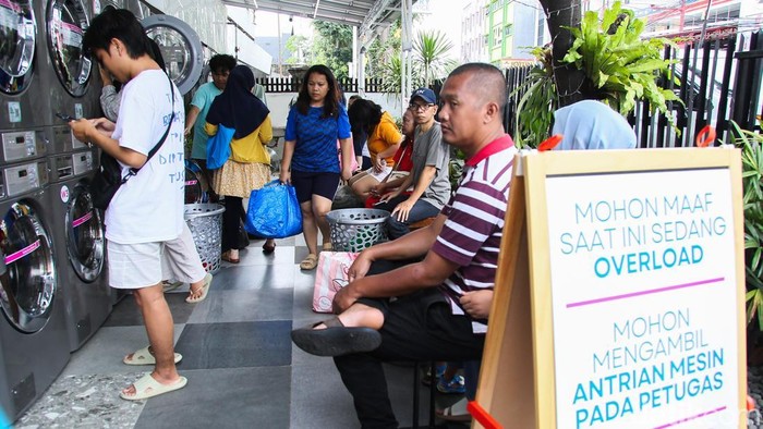 Warga memasukkan pakaian kotor ke dalam mesin cuci di Evi Laundry, Jakarta, Selasa (24/3/2026). Permintaan jasa laundry mengalami lonjakan selama masa libur Lebaran.