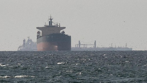 FILE PHOTO: Cargo ships in the Gulf, near the Strait of Hormuz, as seen from northern Ras al-Khaimah, near the border with Oman?s Musandam governance, amid the U.S.-Israeli conflict with Iran, in United Arab Emirates, March 11, 2026. REUTERS/Stringer/File Photo