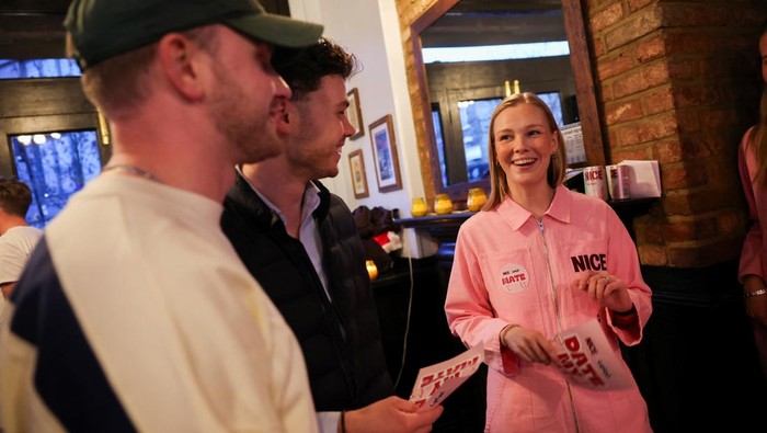 People buy drinks at the bar during 