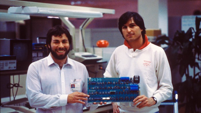 Para pendiri Apple, Steve Jobs dan Steve Wozniak, bersama papan sirkuit awal.