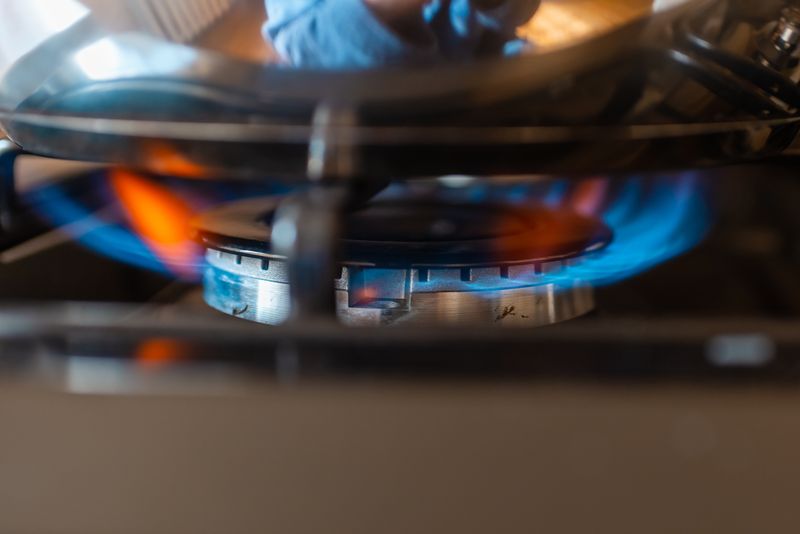 2060095645 Combustion of household gas on a gas stove, gas energy saving concept.Closeup.