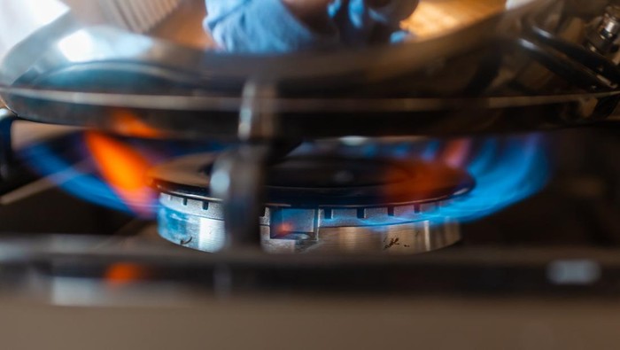 Combustion of household gas on a gas stove, gas energy saving concept.Closeup.