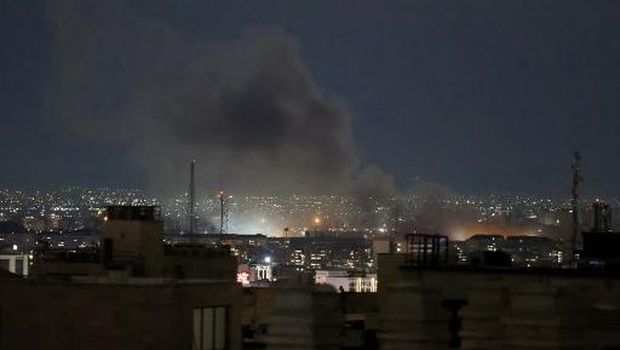 A plume of smoke rises from the site of a strike in Tehran early on March 28, 2026. Israel and the United States launched strikes on Iran on February 28, killing the Islamic republic's supreme leader and sparking a war that has since spread across the Middle East. (Photo by ATTA KENARE / AFP) /