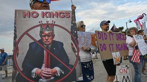 Protesters hold signs and flags near US President Donald Trumps Mar-a-Lago resort during the No Kings national day of protest, in Palm Beach, Florida, on May 28, 2026. Nationwide protests against US President Donald Trump are expected Saturday as millions of people vent fury over what they see as his authoritarian bent and other forms of cruel, law-trampling governance. It is the third time in less than a year that Americans will take to the streets as part of a grassroots movement called No Kings, the most vocal and visual conduit for opposition to Trump since he began his second term in January 2025. (Photo by Giorgio VIERA / AFP)
