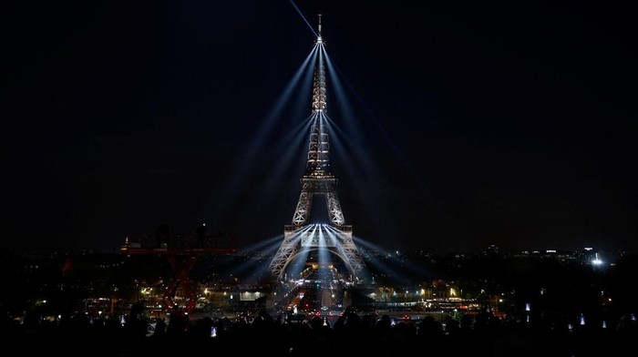 The Eiffel Tower lights up to mark the announcement of concert dates and ticket sales for singer Celine Dion's upcoming ten concerts in September and October in Paris, France, March 30, 2026. REUTERS/Benoit Tessier