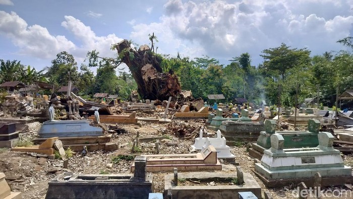 Pohon beringin raksasa di tengah pemakaman umum di Malang tumbang mengangkat sejumlah makam dan jenazah.