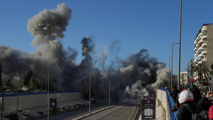 People look at a damaged building following an Israeli strike, amid escalating hostilities between Israel and Hezbollah, as the U.S.-Israel conflict with Iran continues, in Beirut, Lebanon, March 31, 2026. REUTERS/Mohammad Yassine