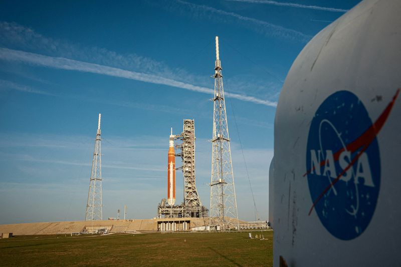 People set cameras to photograph NASA's Artemis II lunar flyby mission, with the next-generation moon rocket, the Space Launch System (SLS) rocket and the Orion crew capsule, on Pad 39B ahead of the launch of the Artemis II mission at the Kennedy Space Center in Cape Canaveral, Florida, U.S.,  March 31, 2026.    REUTERS/Brendan McDermid         TPX IMAGES OF THE DAY     REFILE - CORRECTING INFORMATION FROM 