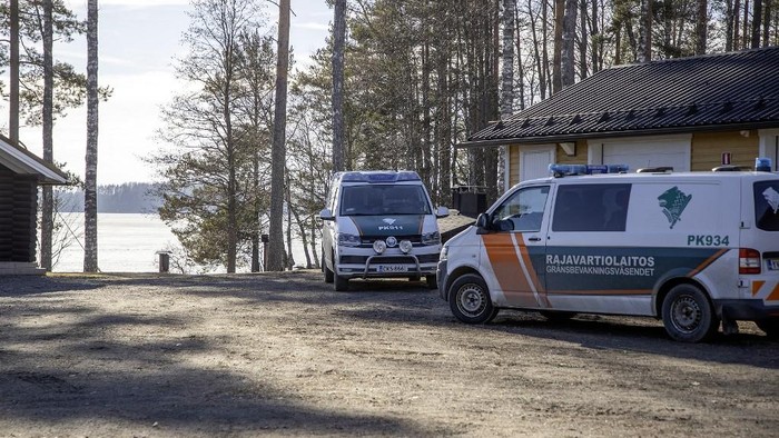 Vehicles of the Finnish Border Guard stand at the former Border Guard station of Narsakkala by the Lake Pyhajarvi in Kitee, eastern Finland, on April 1, 2026. Finnish authorities on April 1, 2026 confirmed a fallen drone on a frozen lake near Finland