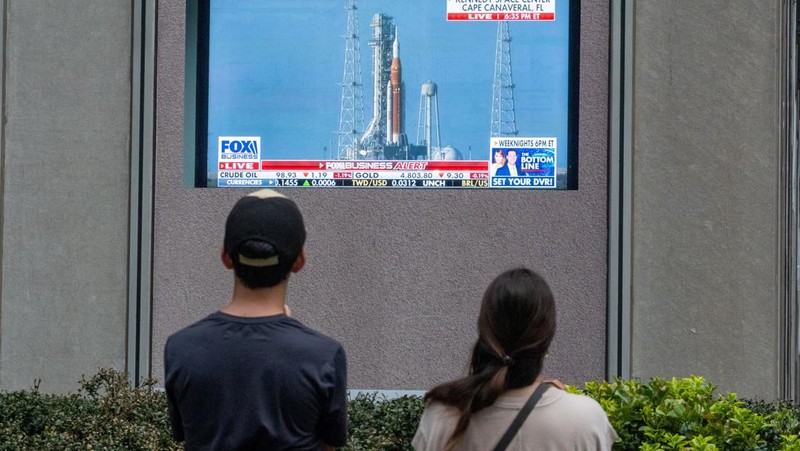 People watch the launch of NASA's Artemis II mission to fly by the moon on a screen at News Corp. plaza in Manhattan, in New York City, U.S., April 1, 2026. REUTERS/David 'Dee' Delgado