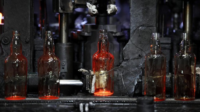 A worker checks the quality of bottles being manufactured inside a glass factory amid fuel supply disruptions following the U.S.-Israeli conflict with Iran, in Firozabad in the northern state of Uttar Pradesh, India, March 26, 2026. REUTERS/Bhawika Chhabra
